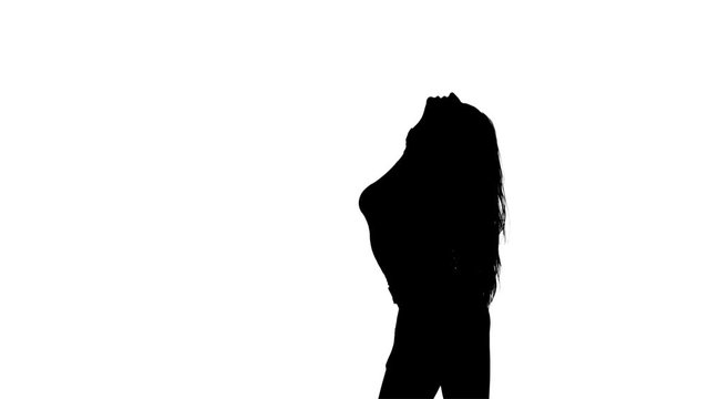 Girl is posing for a camera, for a magazine. Silhouette. White background