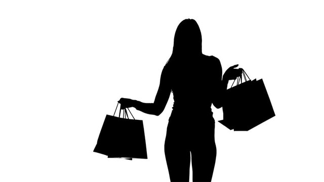 Girl with packages in hands posing for cameras. Silhouette. White background