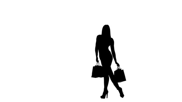 Girl with packages in hands posing for a camera, she is on high heels. Silhouette. White background