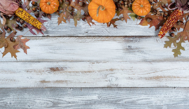 Autumn decorations on rustic white wood in top arch border