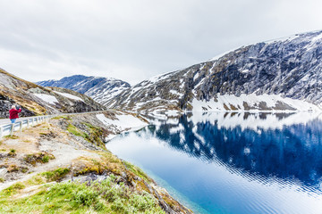 Tourist taking photo by Djupvatnet lake, Norway