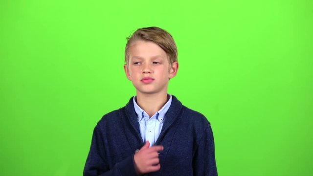 Boy is thinking about important things. Green screen. Slow motion