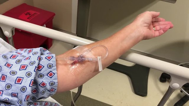 A woman gets an IV in a hospital's emergency room.	