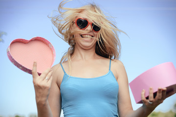 Joyful young woman happy smile hold gift box in hands, bright close up portrait. Emotional delight...