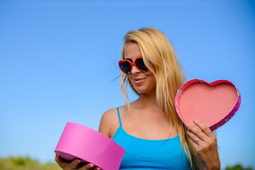 Joyful young woman happy smile hold gift box in hands, bright close up portrait. Emotional delight...