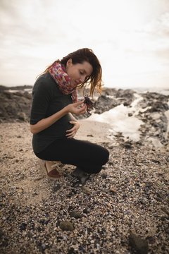 Pregnant woman holding a sea shell