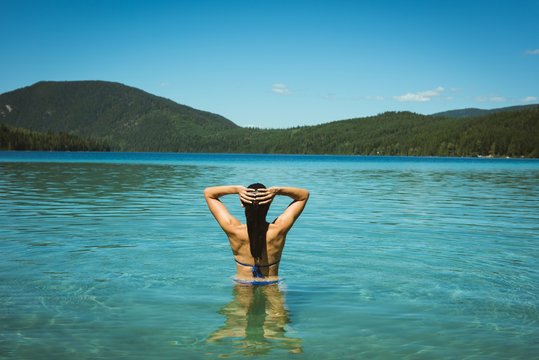 Rear view woman standing in river