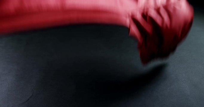 American football jersey fabric falling on black background 