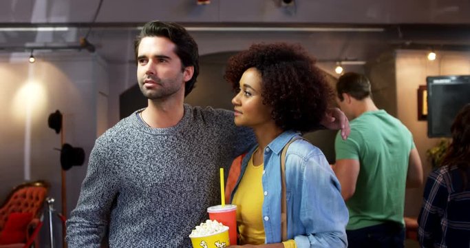 Couple standing with arm around 