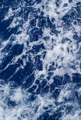 Fototapeta premium white foam on saturated dark blue sea water
