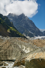 View of the glacier and rocky mountain under the blue sky and cloud