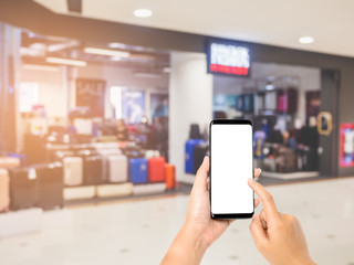 Hand holding smartphone on shopping mall background blurred, Hand ready to take a photo