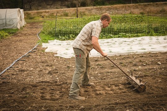 Farmer ploughing a field with agriculture equipment