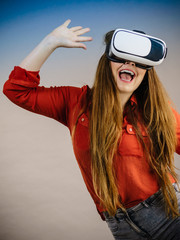 Girl wearing virtual reality goggles.