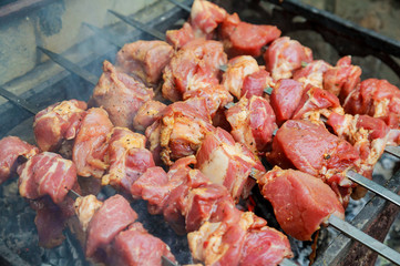 closeup of some meat skewers being grilled barbecue