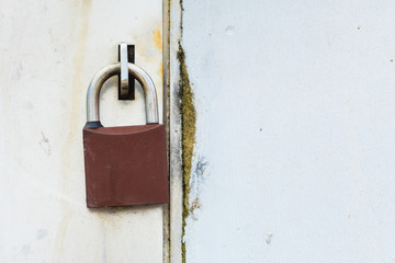 Closed padlock on the white metal door