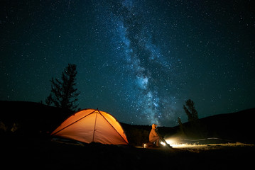 Tourist near his camp tent at night. - 178168621