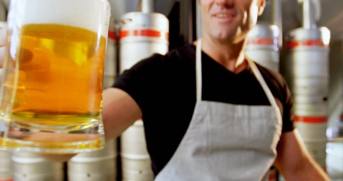 Close-up of brewer testing beer 