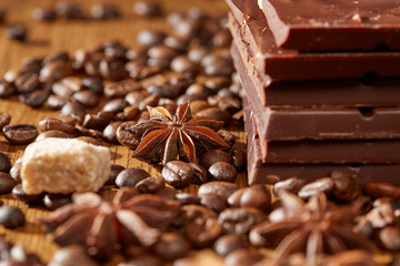 Aroma coffee chocolate cookies and spices on the wooden table. Dark wooden background. Top view. Close. Closeup.