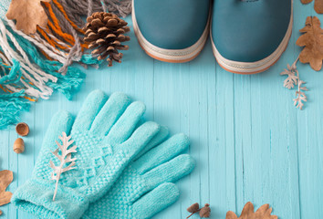 blue winter shoes and gloves on blue wooden background