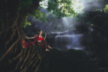 women wearing typical Thai dress at waterfall