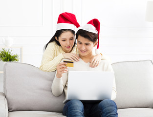 Happy Couple Using Credit Card to Internet Shopping.