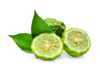 whole and half of green fresh bergamot with green leaves isolated on white background