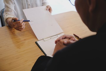 Legal counsel presents to the client a signed contract with gavel and legal law. justice and lawyer...