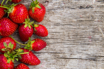 Ripe fresh strawberries on rustic wooden background with copy space. Top view