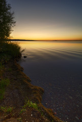 Fototapeta na wymiar Beautiful evening view of a lake on a sunset background.