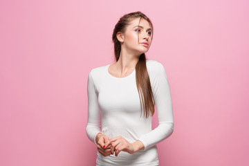Fototapeta premium The young woman's portrait with thoughtful emotions