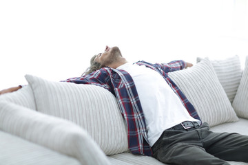 Obraz premium handsome successful guy resting on the couch.