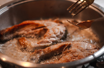 Fillet of fresh fish carp on a plate in flour ready for cooking.