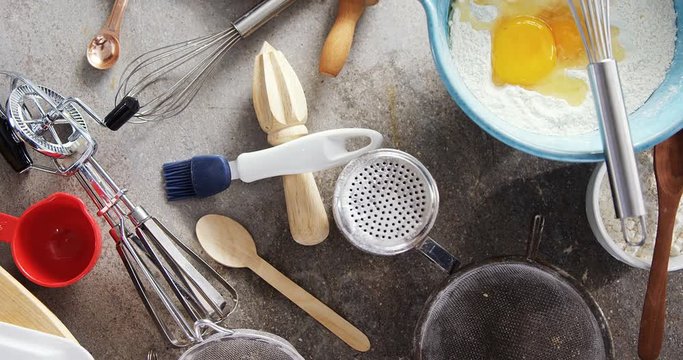 Gingerbread cookies ingredients with various utensils on table 