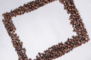 Frame of coffee beans with free space for text, white background top view