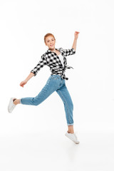 Full length image of happy ginger woman in shirt
