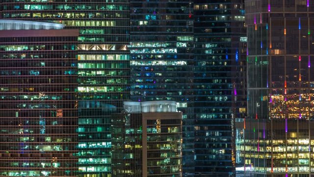 Modern office building with glowing windows at night timelapse. Moscow city