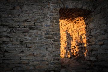 Shadows of people walking on stone wall at sunset