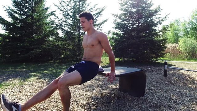 Male athlete using bench to work out