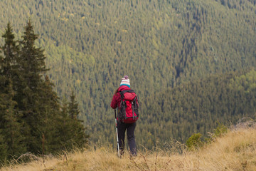 young woman hiker in autumn forest  