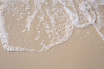 The movement of the waves on the sand is smooth and fine for  background,