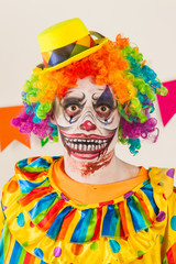 a terrible clown. Halloween. The crazy clown. Childish fear