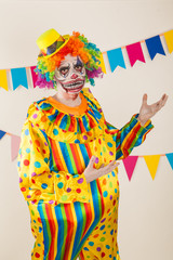 a terrible clown. Halloween. The crazy clown. Childish fear