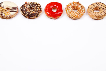 Delicious donuts with chocolate almond, strawberry jam, peanut butter, white chocolate and almond caramel glazed, Isolated on white background.