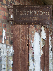 rusted sign on brick wall