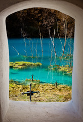 church with its cemetery under contaminated water in Geamana, Romania. Polluted lake with mining residuals that destroyed a village.