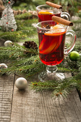 Christmas hot mulled wine with cinnamon, orange and christmas tree on board. Winter tradition drink.