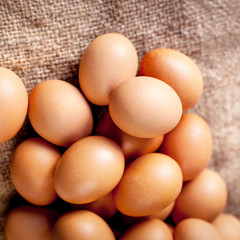 Large brown  Eggs on burlap   background closeup