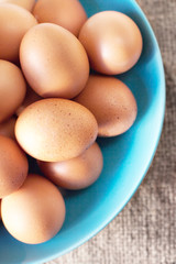 Large brown  Eggs on burlap   background closeup