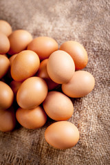 Large brown  Eggs on burlap   background closeup